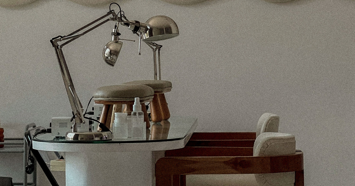 photo of a table with two chairs and a lamp most likely used for getting a manicure.